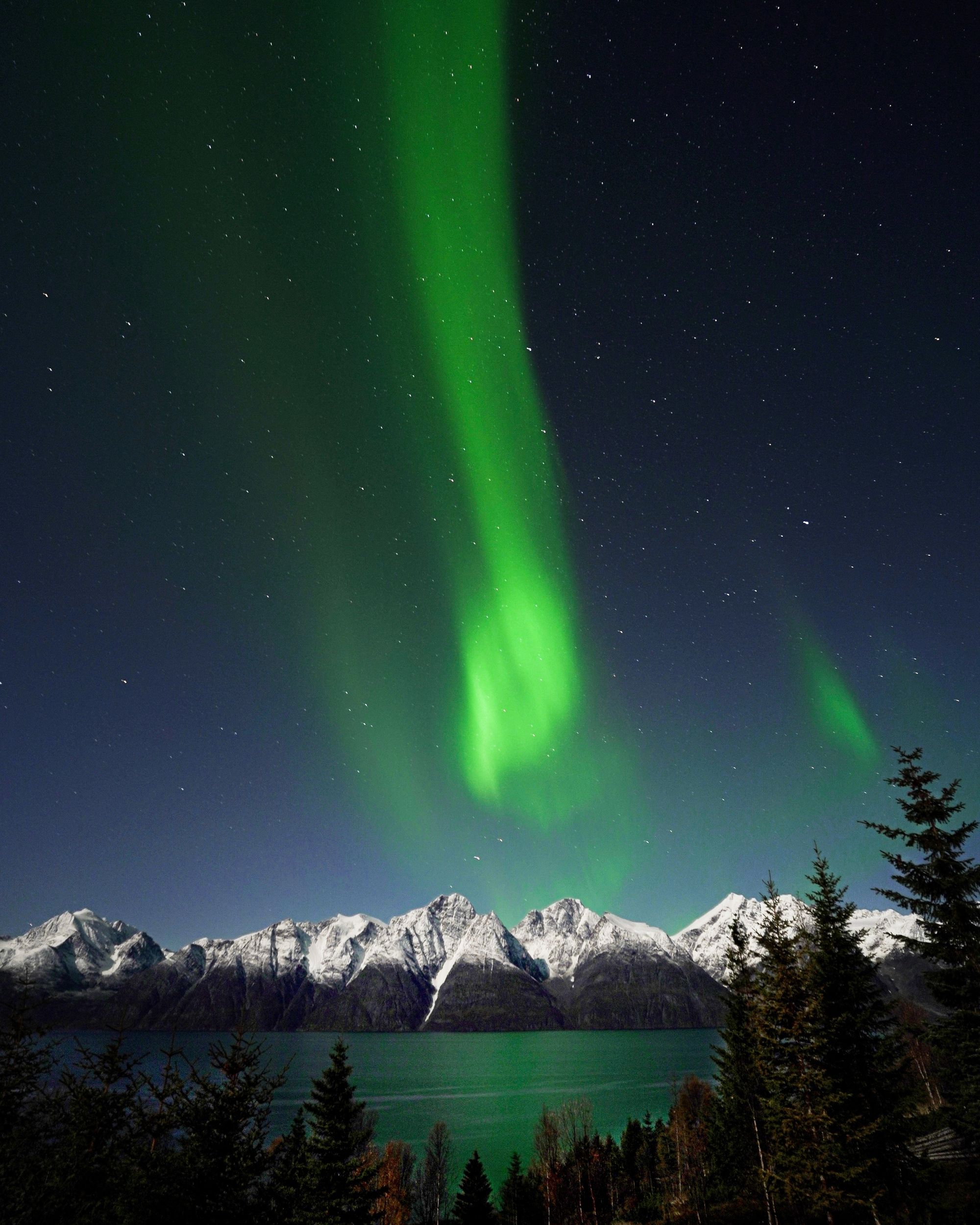 Photo - Northern lights over snowy mountains